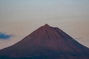 A majestic volcano under a soft twilight sky.
